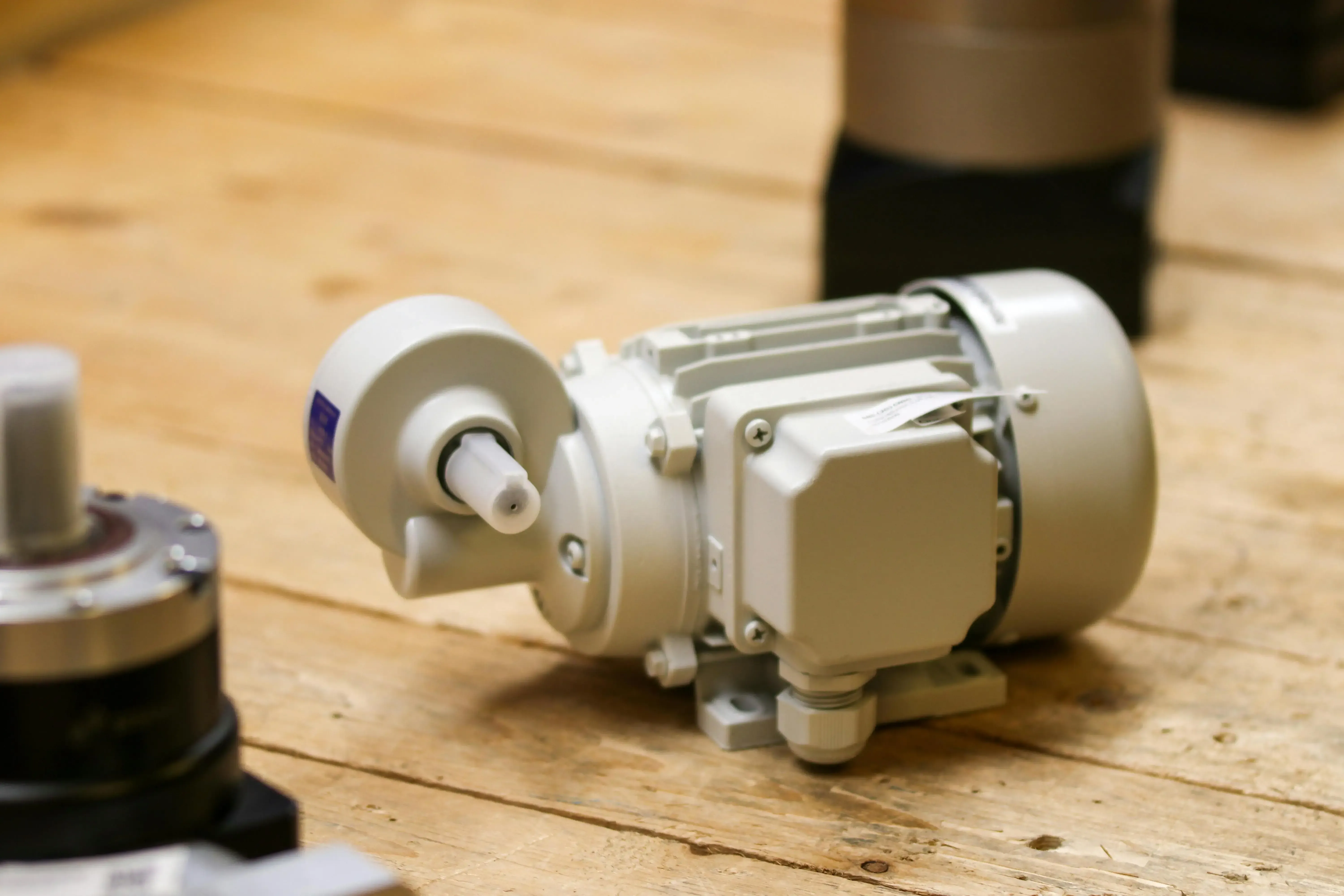 Industrial electric motor resting on a wooden workbench