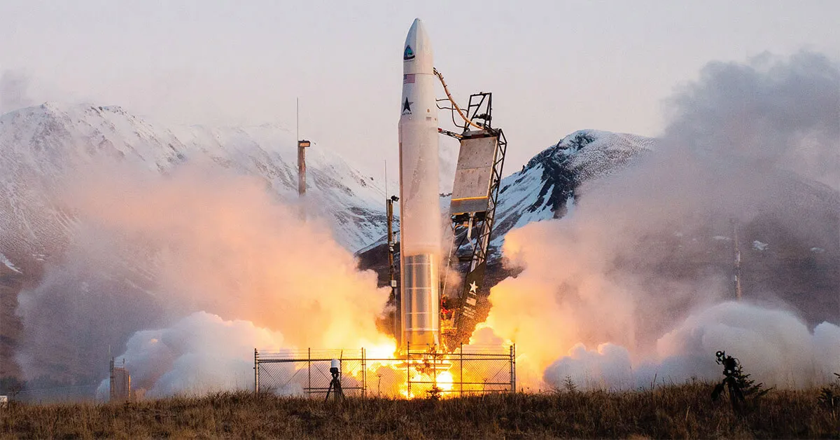 Rocket lifting off from a launch pad surrounded by fire and exhaust clouds
