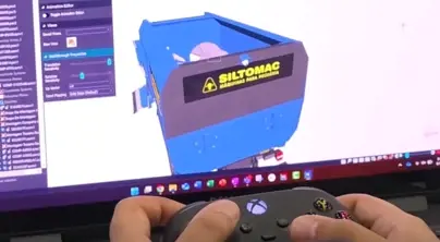 Hands holding an Xbox controller to navigate a Solid Edge machine model with the Walkthrough command